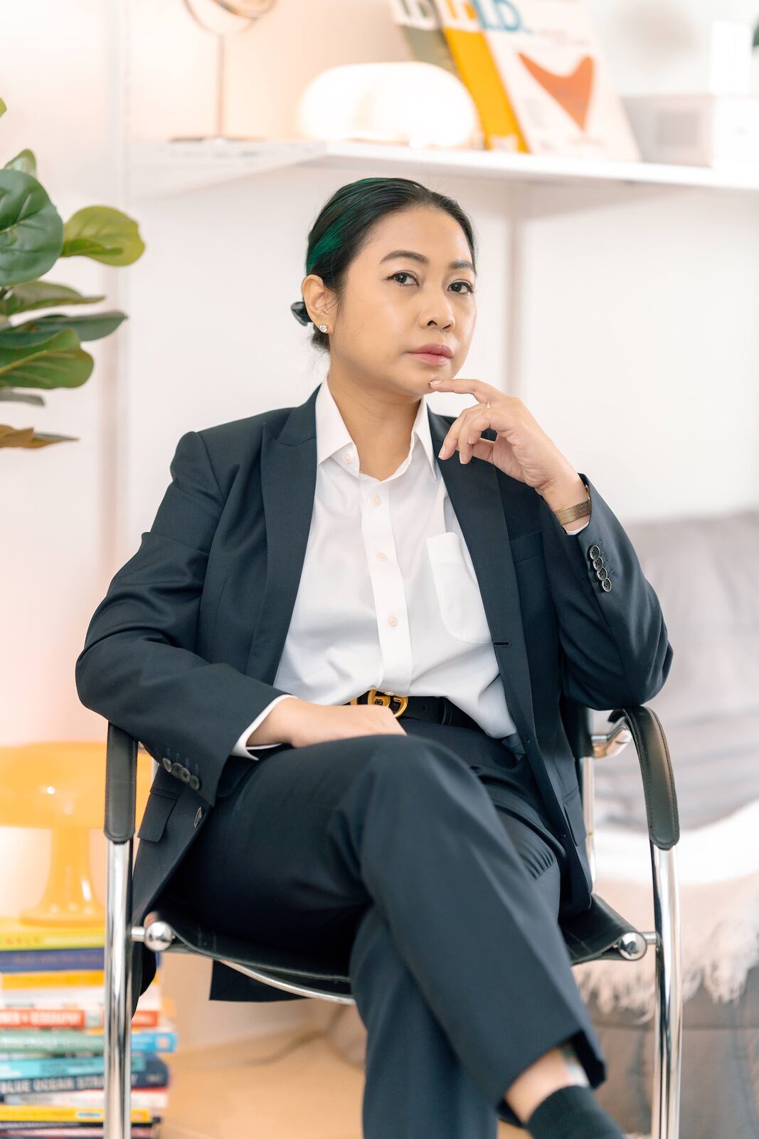 Fleire Castro — seated portrait, navy suit